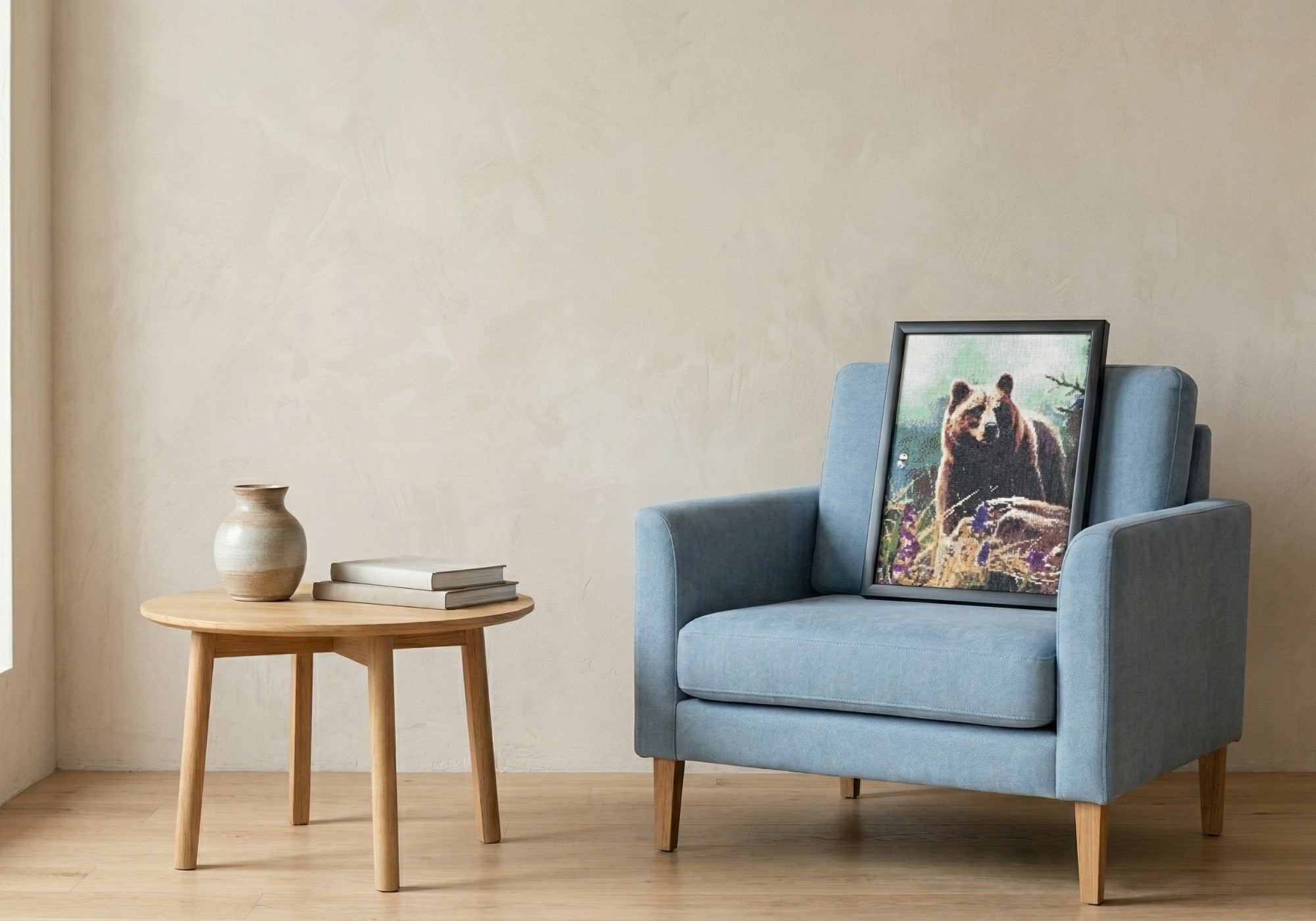 Bear handcrafted grizzly bear crystal micro-mosaic wall art by Lunarti leaning on a blue armchair.