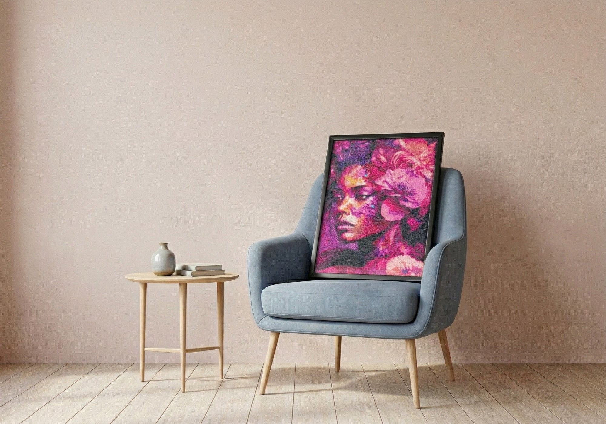 Black Swan handcrafted pink floral crystal micro-mosaic wall art by Lunarti leaning on a blue armchair.